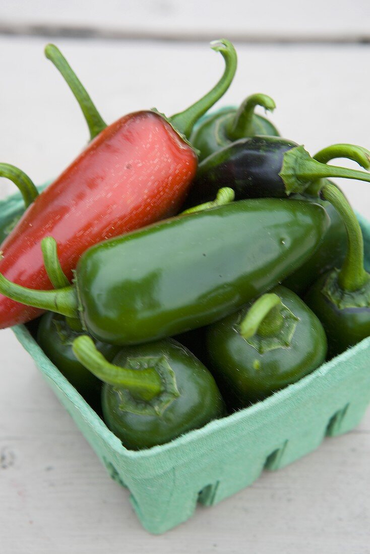 Jalapeno peppers in a cardboard box