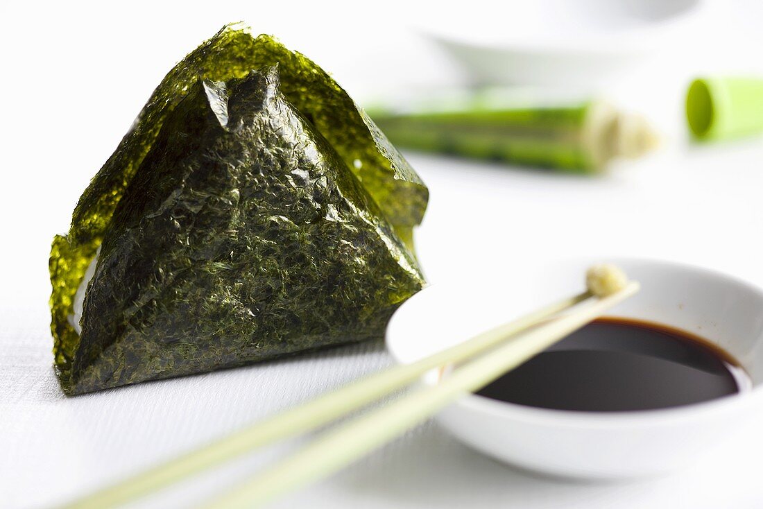 Onigiri (rice canape in a nori leaf filled with salmon, Japan) with soya sauce