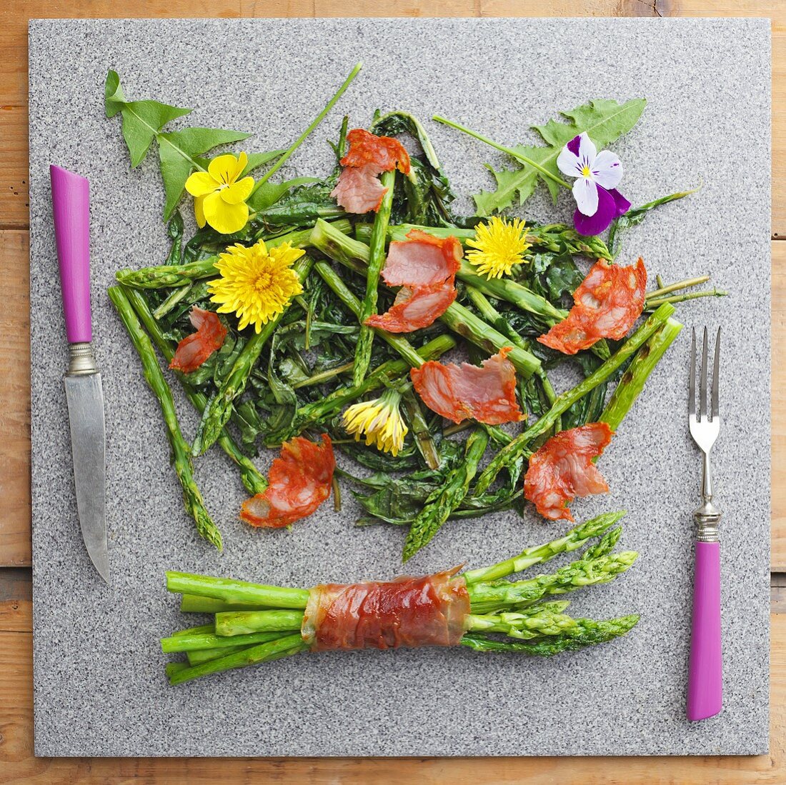 Roasted green asparagus with parma ham and edible flowers