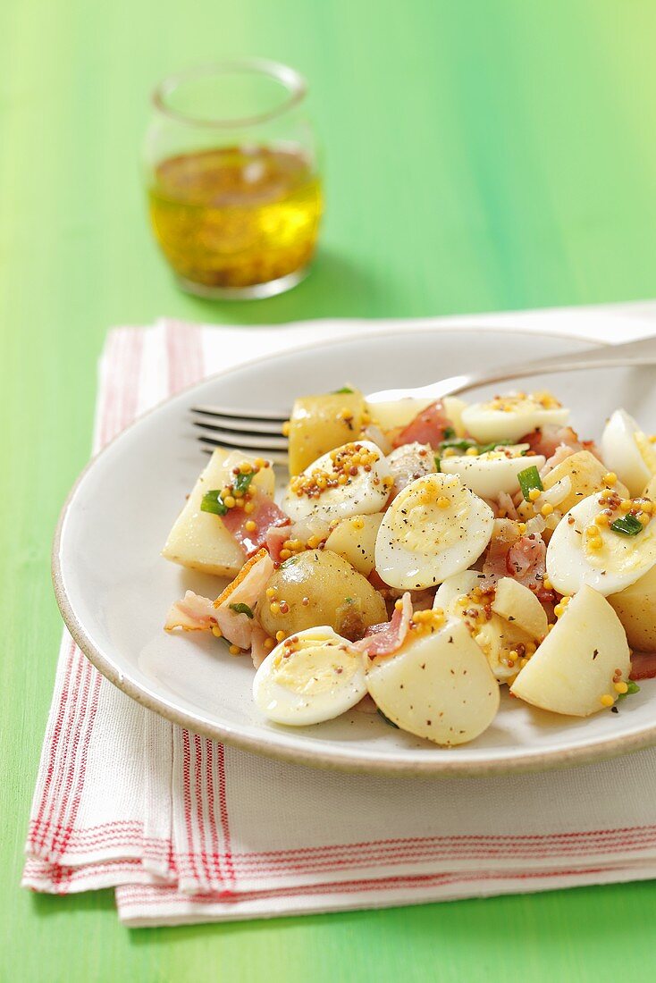 Potato salad with quail's eggs, bacon and a mustard dressing