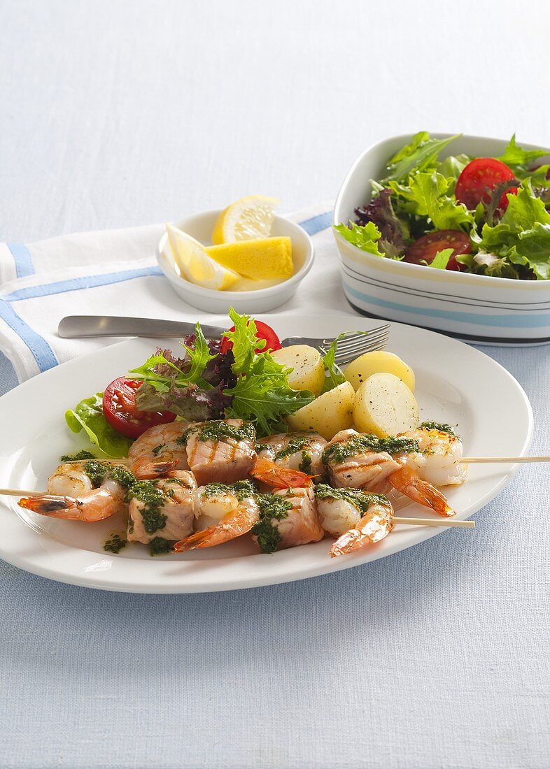 Salmon and prawn kebabs with a side salad