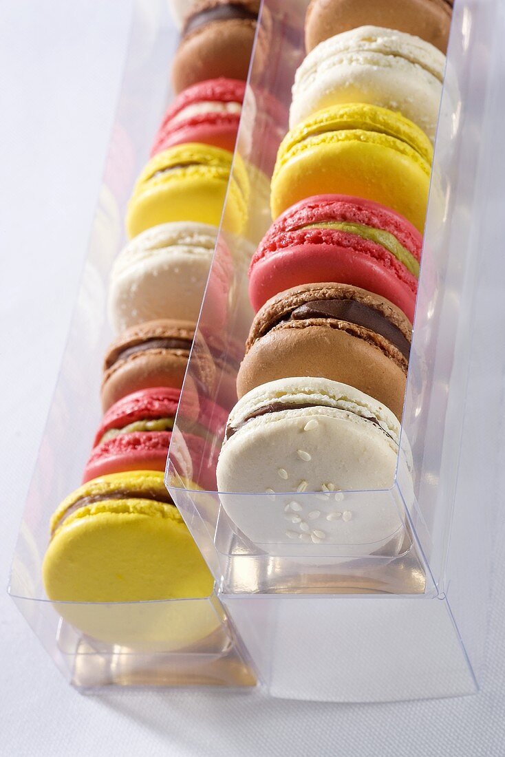 Various macaroons in plastic boxes