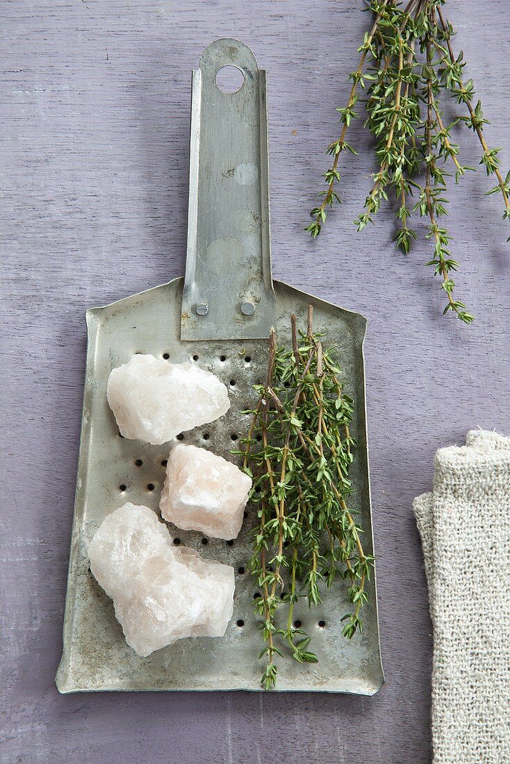 Salt and sprigs of thyme on a grater