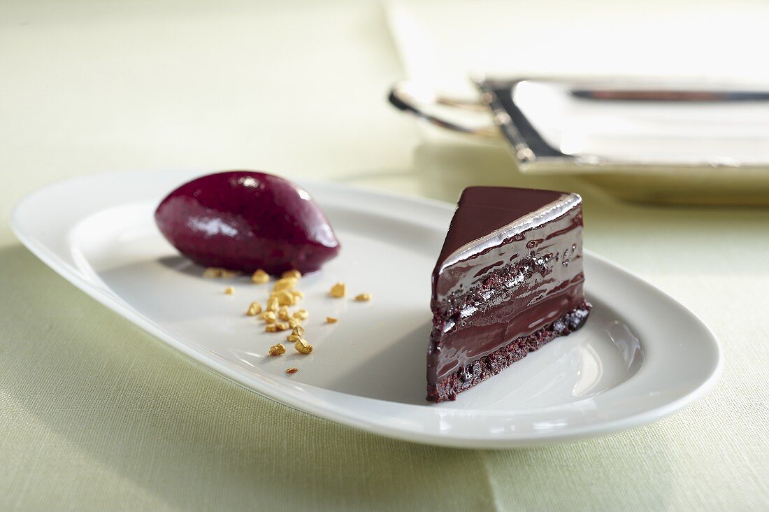 A piece of chocolate cake with blackcurrant sorbet
