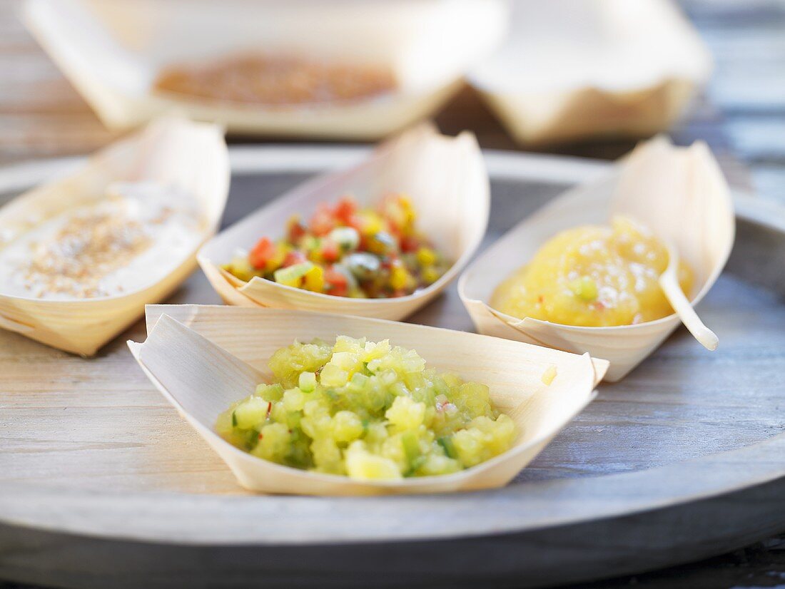 Various dips (pineapple salsa, peanut sauce, cucumber dip, salsa)