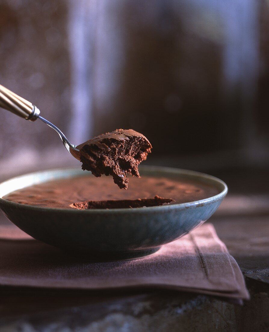 Mousse au chocolat in a bowl and on a spoon