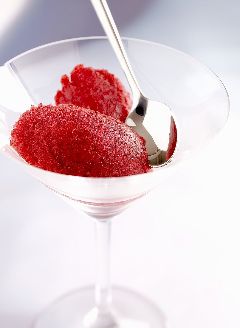 Raspberry sorbet in a stem glass