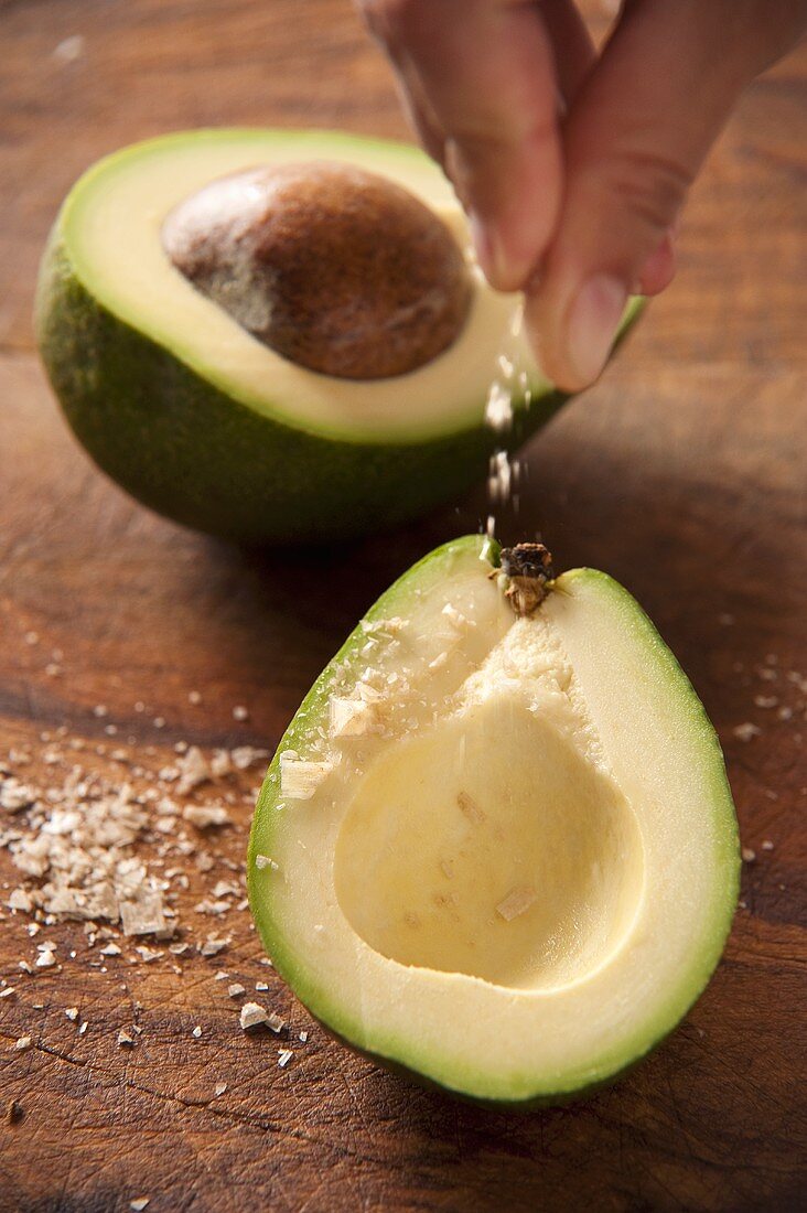 Fleur de Sel being sprinkled onto an avocado