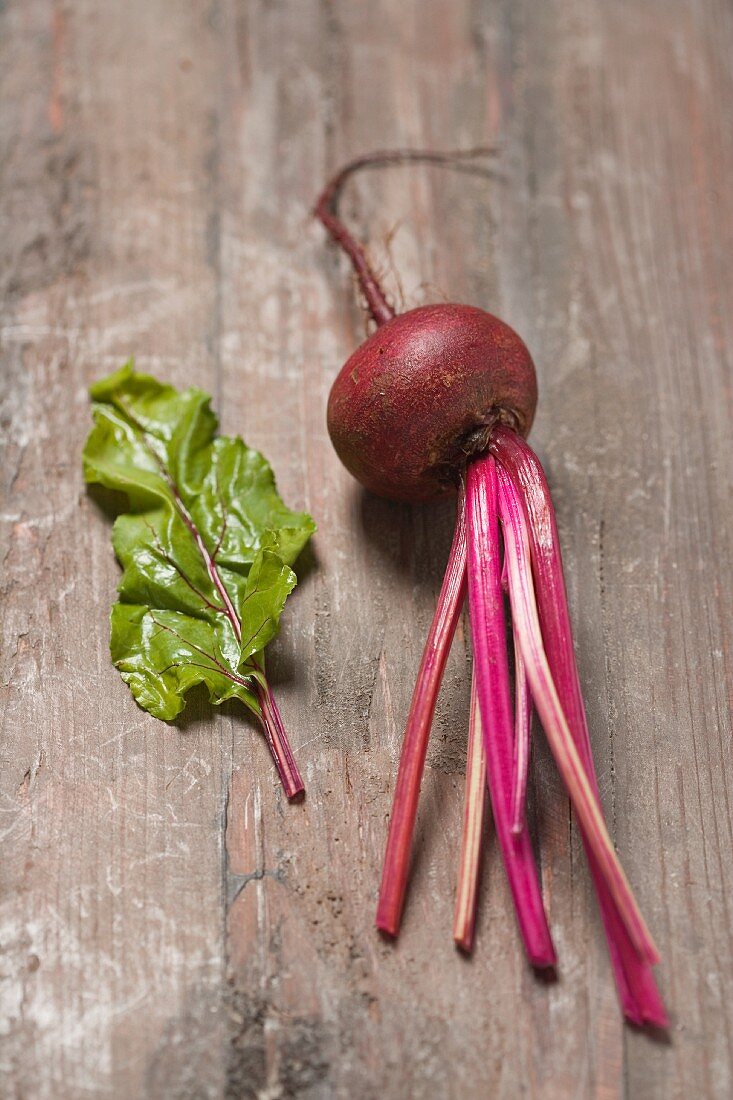 Beetroot with leaves on a wooden surface