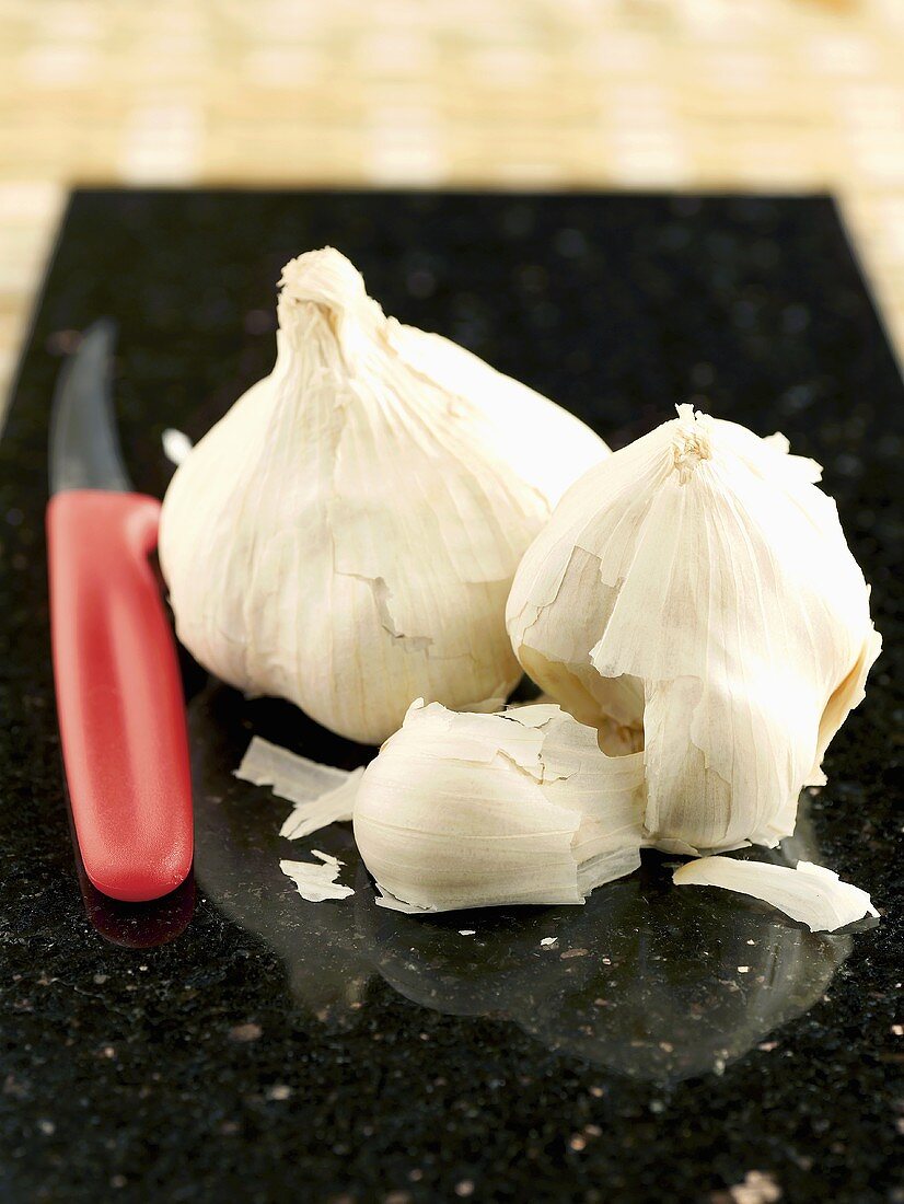 Garlic bulbs and a vegetable knife