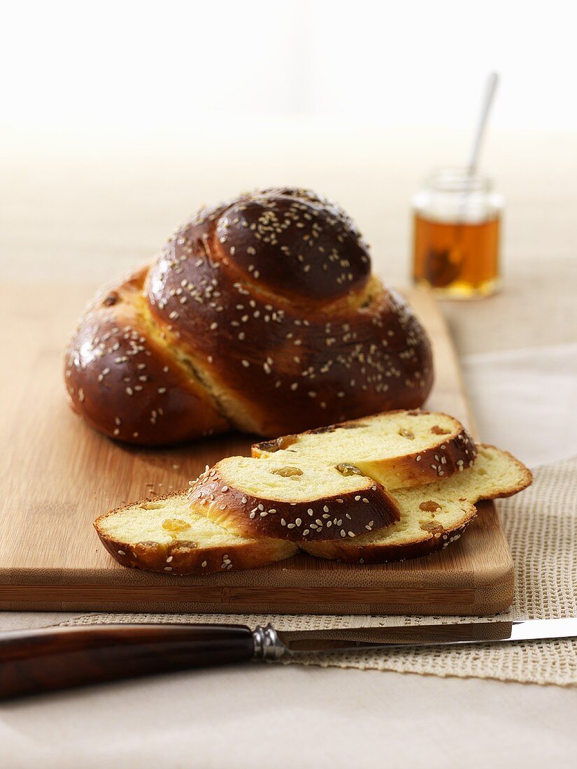 Challah with raisins and a jar of honey