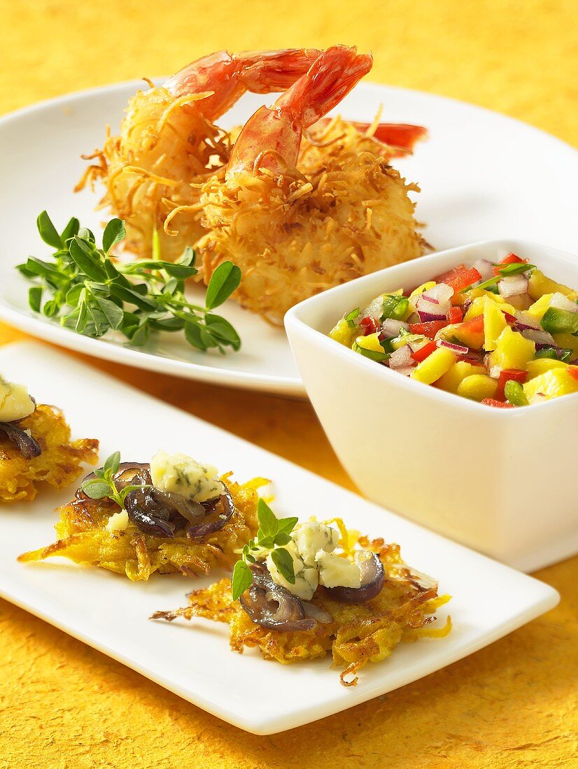 Various appetisers: potato cakes, coconut prawns and fruit salsa