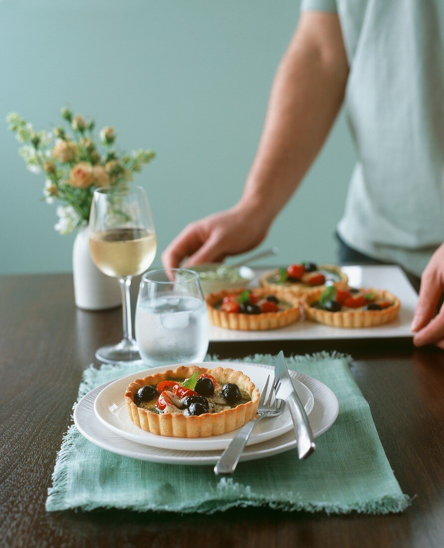 Olive and tomato tartlets with basil
