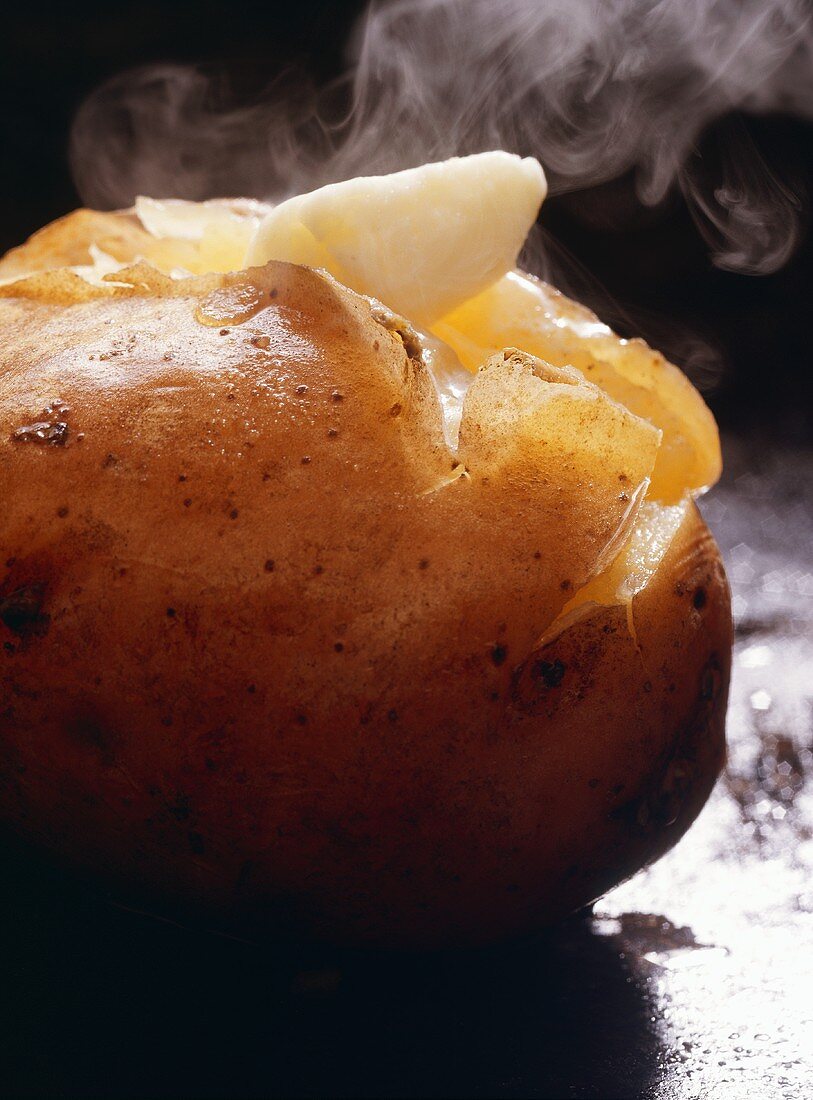 A Steaming Baked Potato with Melting Butter
