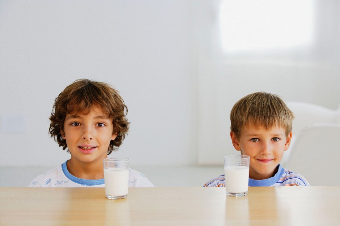 Two brothers with glasses of milk