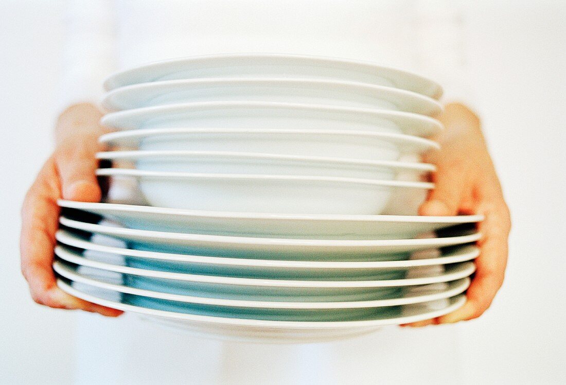 Holding a stack of plates