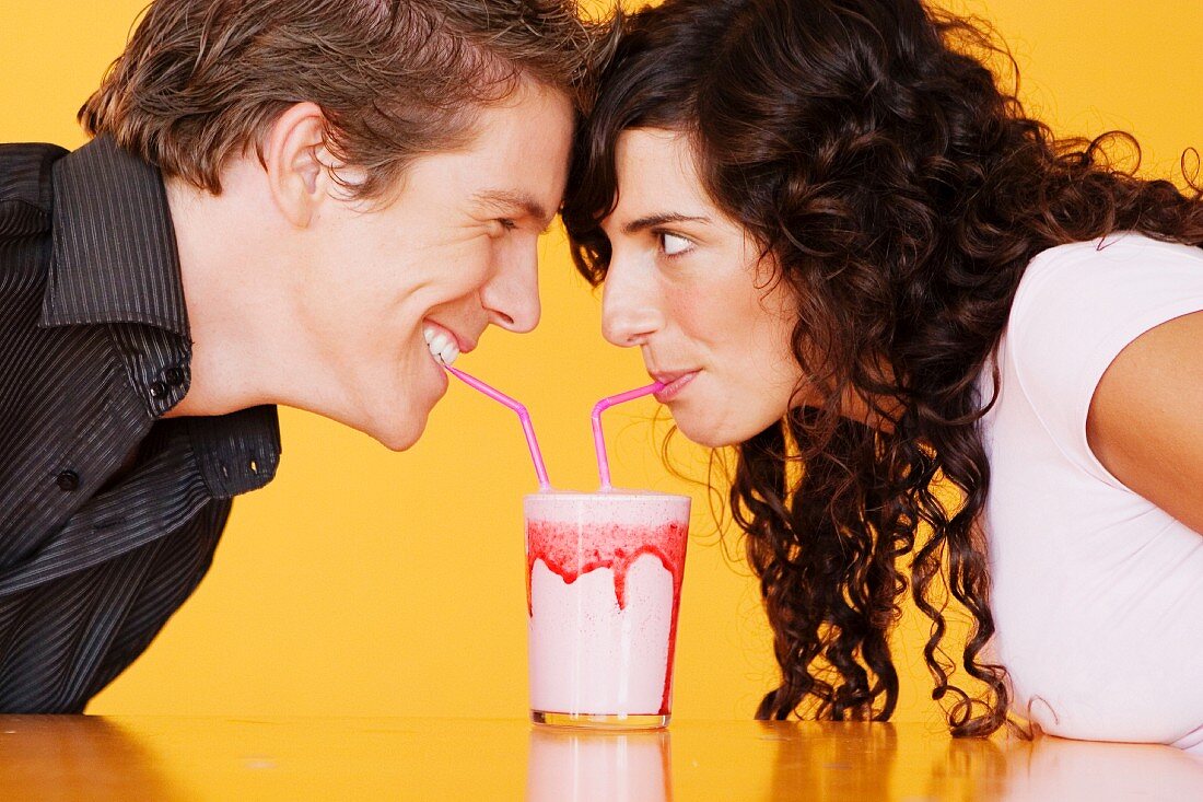 Couple sharing a milkshake