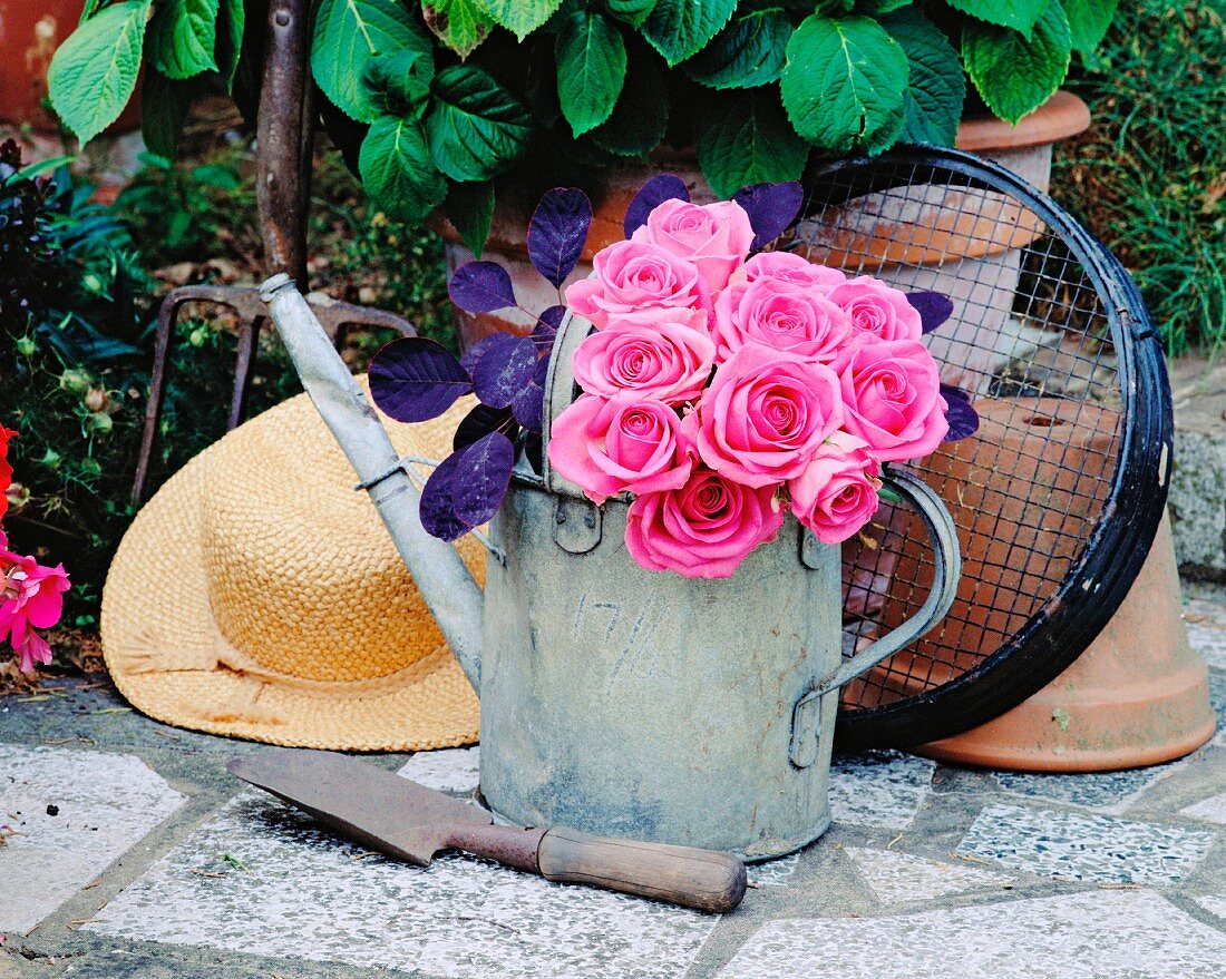 Bouquet of roses in a watering can