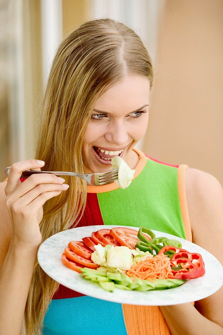 Young woman eating crudités