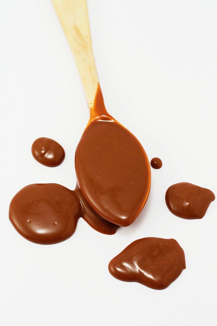 Melted chocolate in wooden spoon
