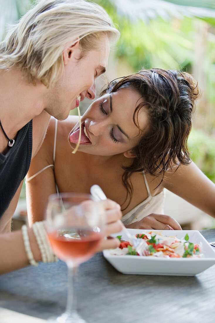 Young couple eating pasta