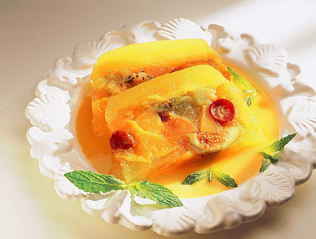 Terrine mit Früchten in Gelee und Mangopüree