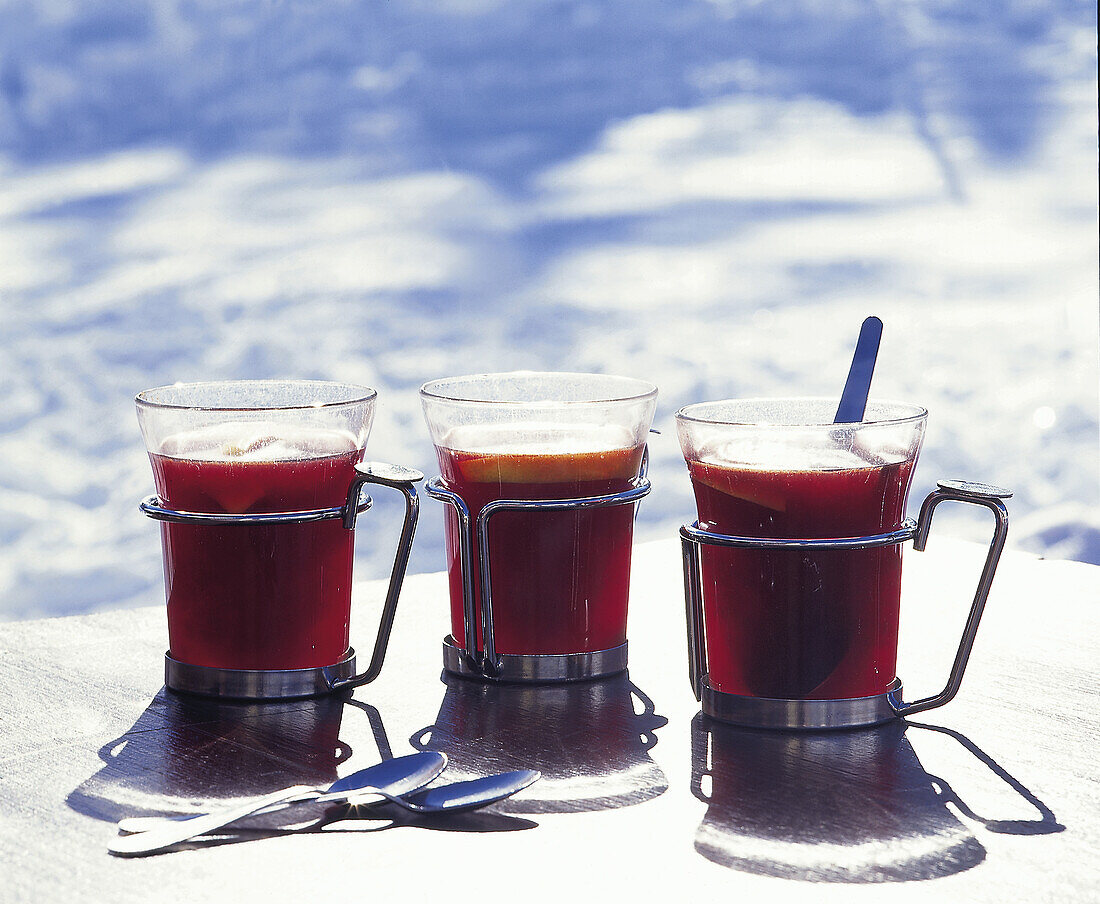 Mugs of mulled wine with cinnamon