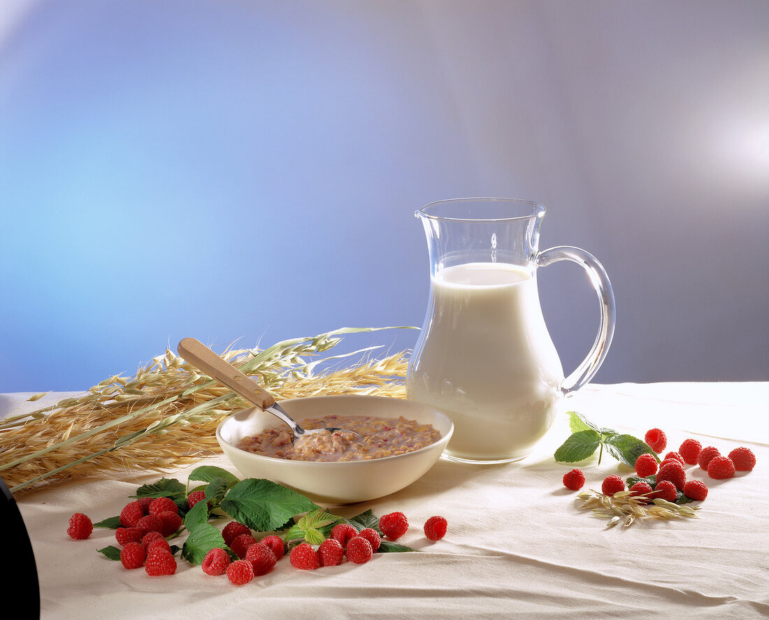 breakfast with milk, cereals and raspberries