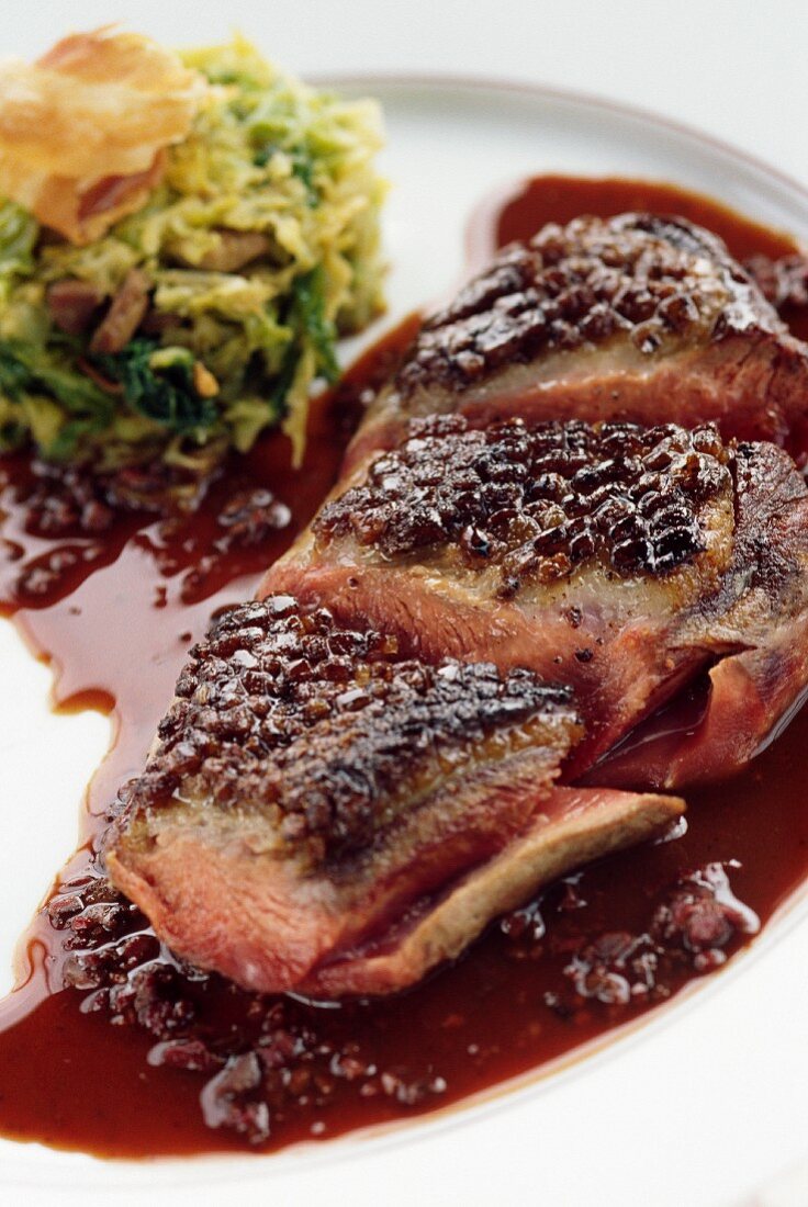 Duck magret, skin with honey and cabbage embalmed