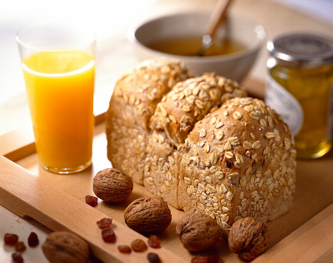 wholewheat bread, walnuts, raisins, cereal and orange juice