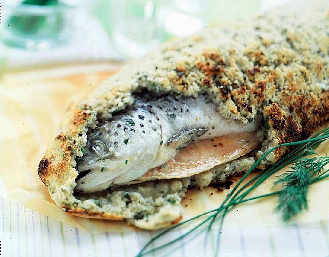 A whole salmon in a salt coating