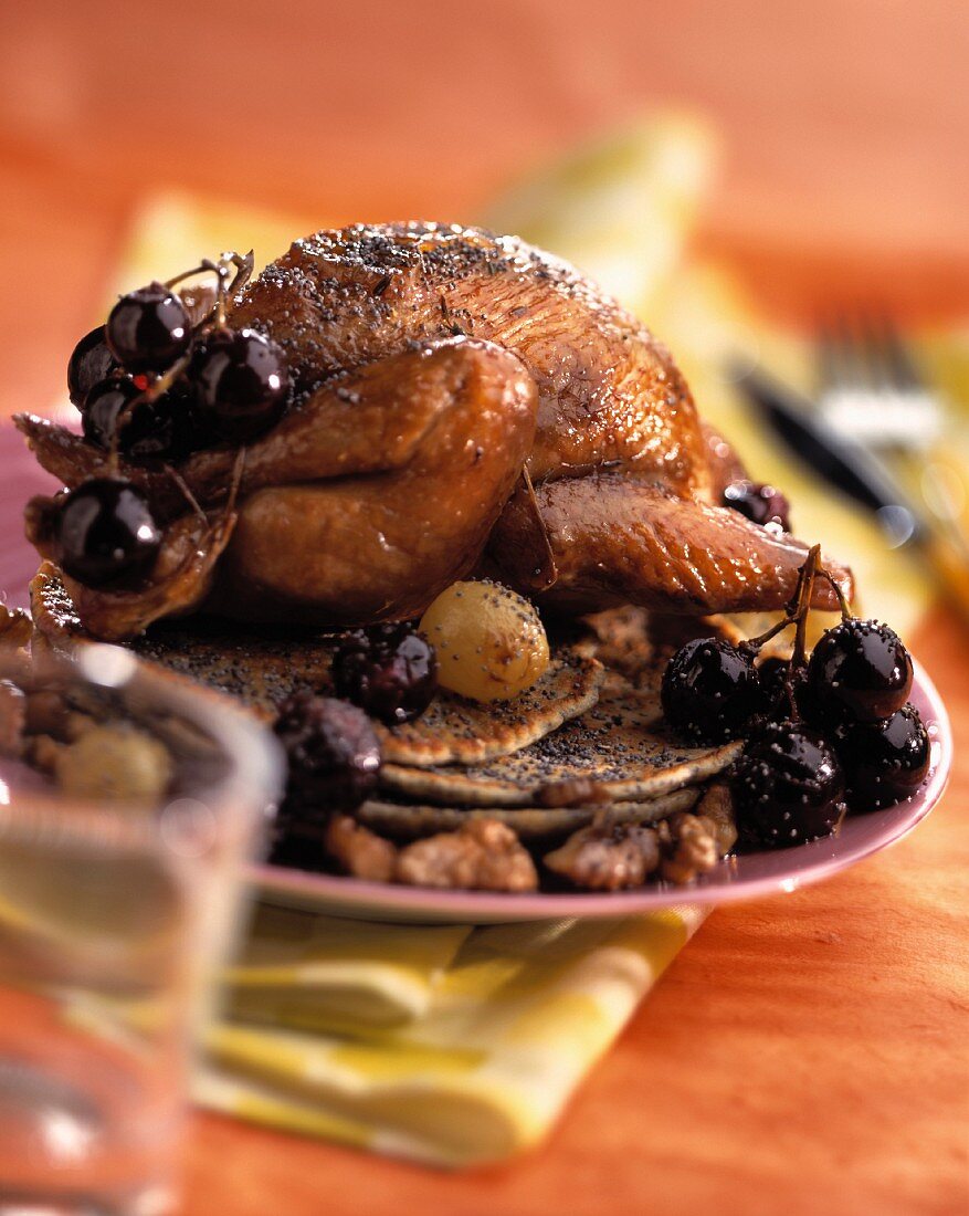 Pigeon with grapes and walnuts and poppy seed pancakes