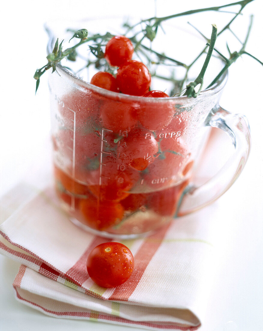 Measuring jug and cherry tomatoes