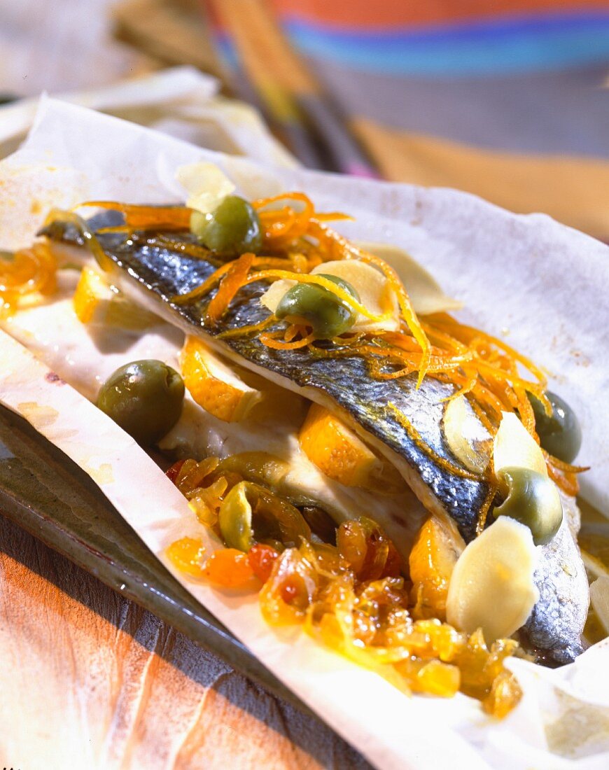 Sea bream with orange and green olives cooked in wax paper