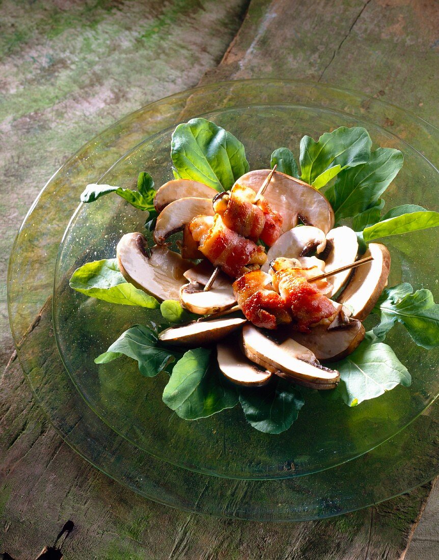 Raw button mushroom salad with mussels wrapped in bacon
