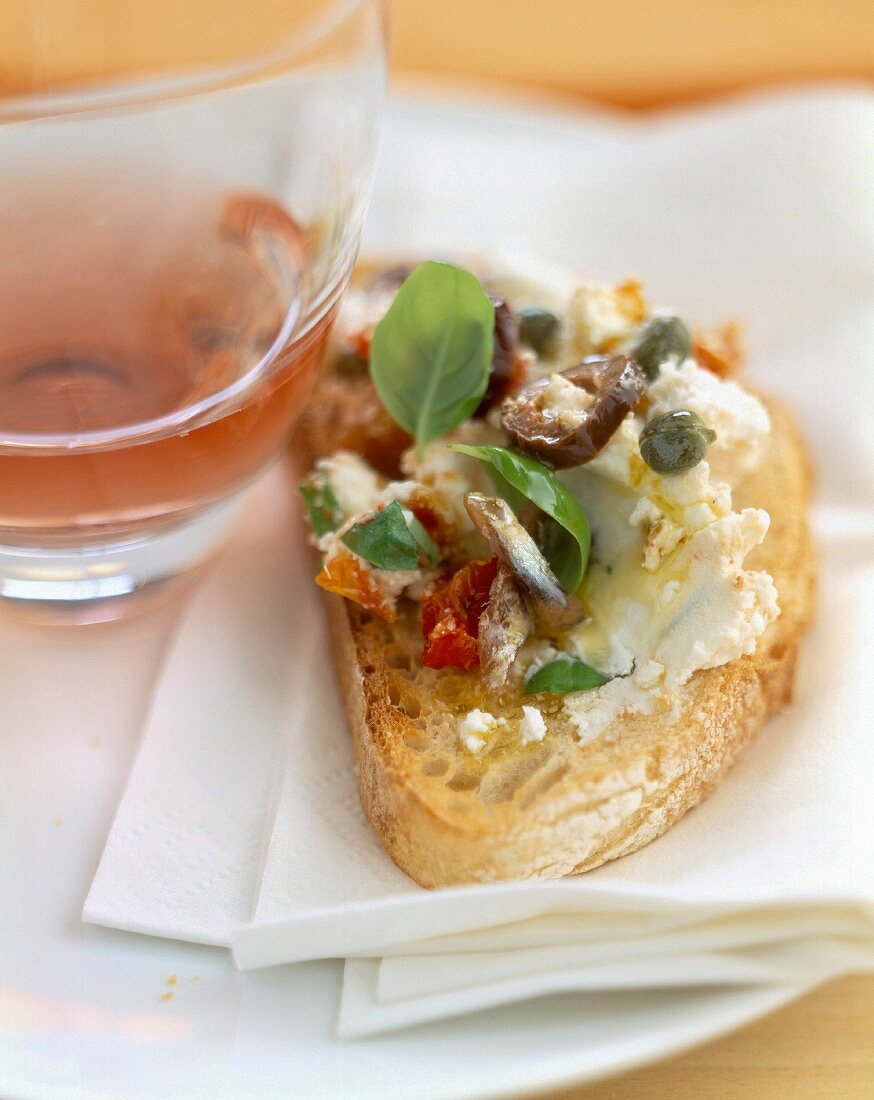 goat's cheese, olives and anchovies on bread