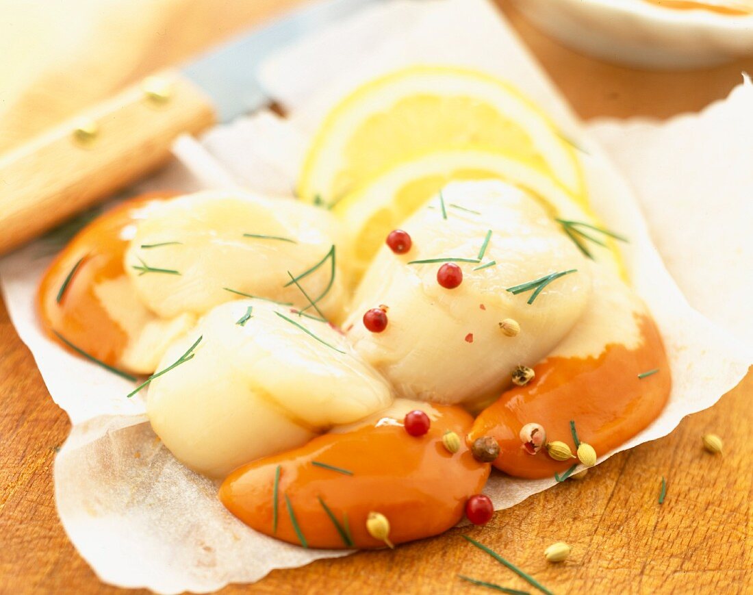 Raw scallops on a chopping board