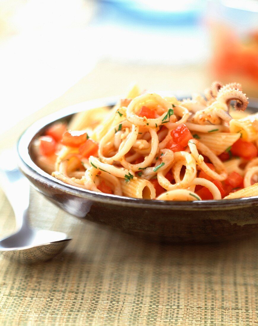 Penne pasta with squid and tomatoes