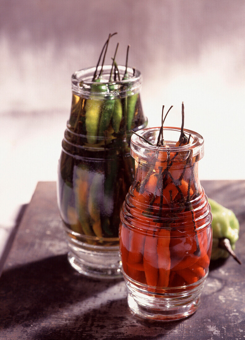 Jars of chili peppers in whiskey