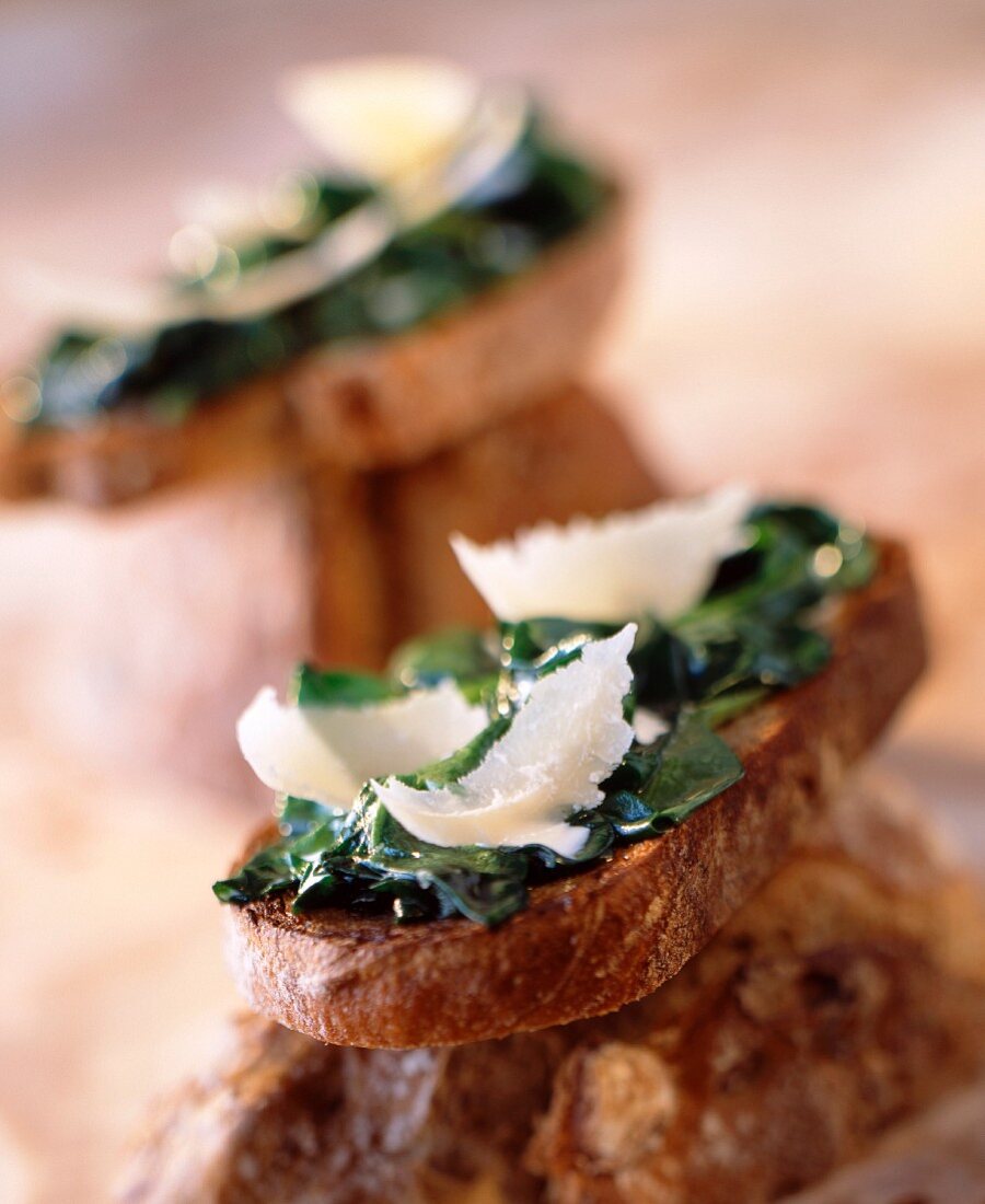 Spinach shoots and parmesan on bread