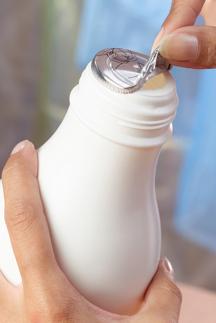 Opening bottle of milk