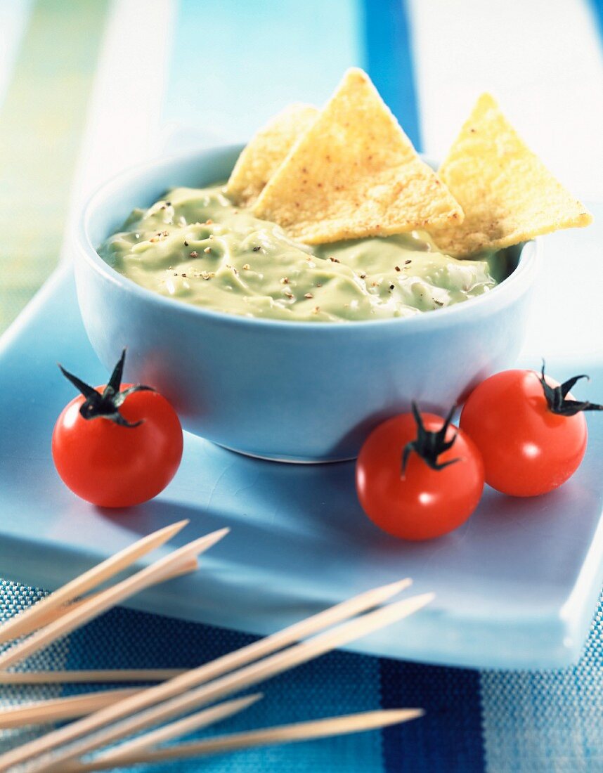 Bowl of Guacamole with cherry tomatoes