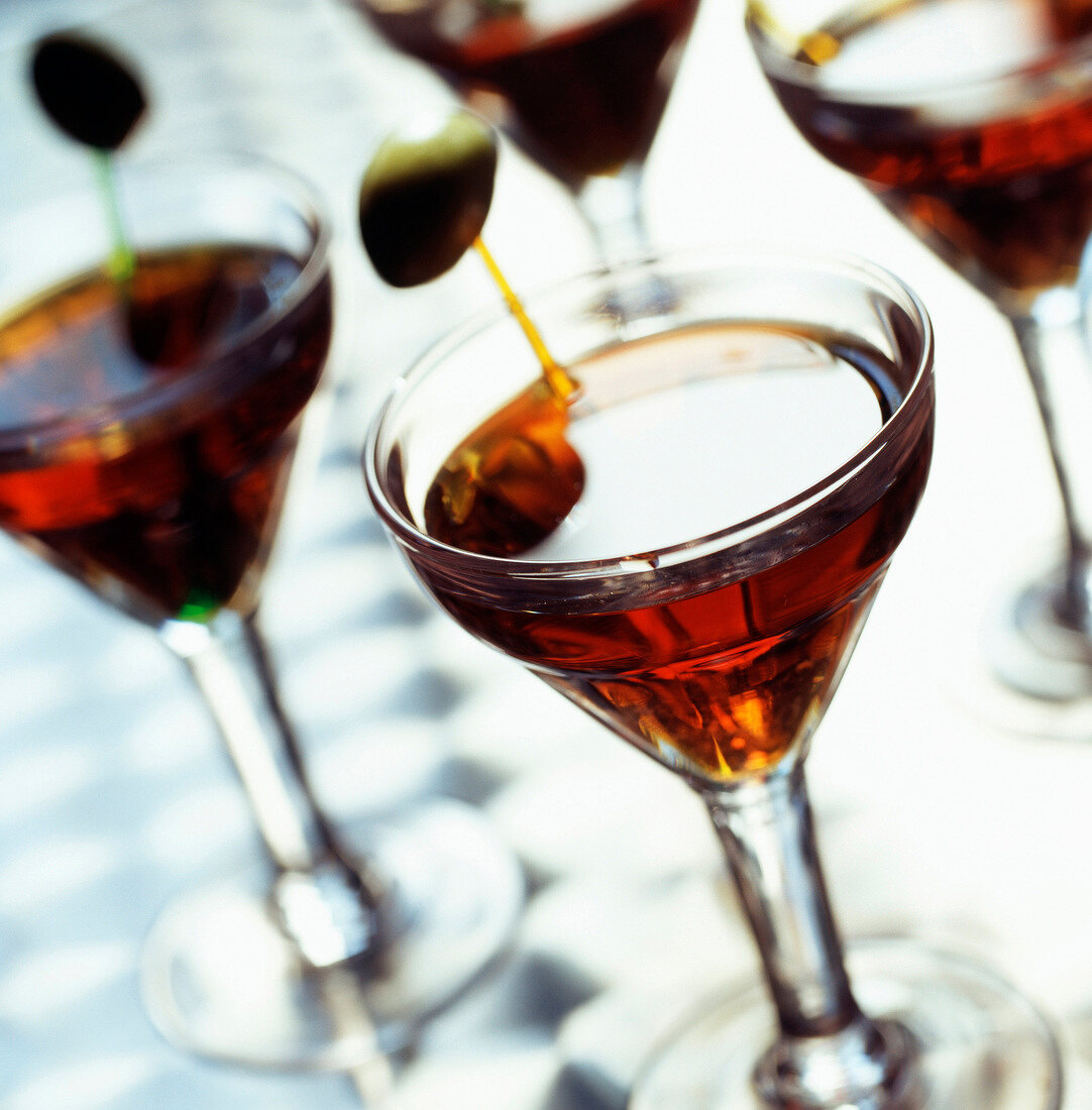 Gläser mit rotem Martini und Oliven-Spiesschen