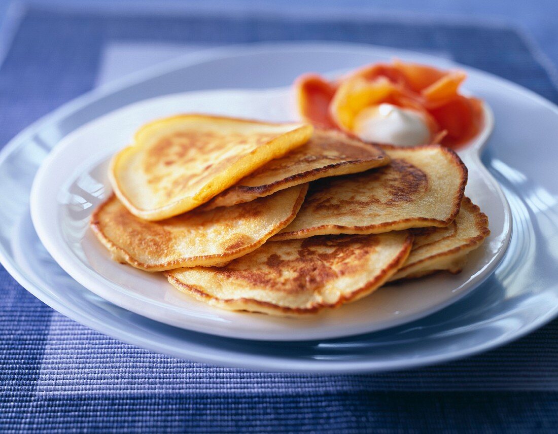 Small thick pancakes with salmon