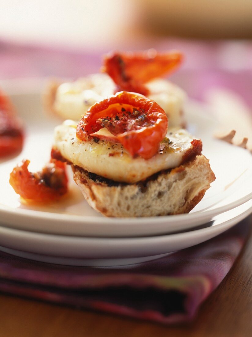 Warm cabecou cheese and dried tomatoes on toast