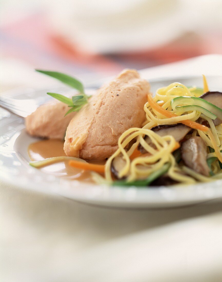 Pike quenelles with sauteed noodles and vegetables