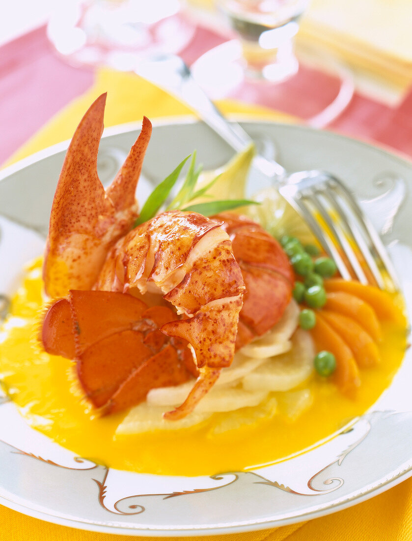 Lobster with baby vegetables in orange sauce