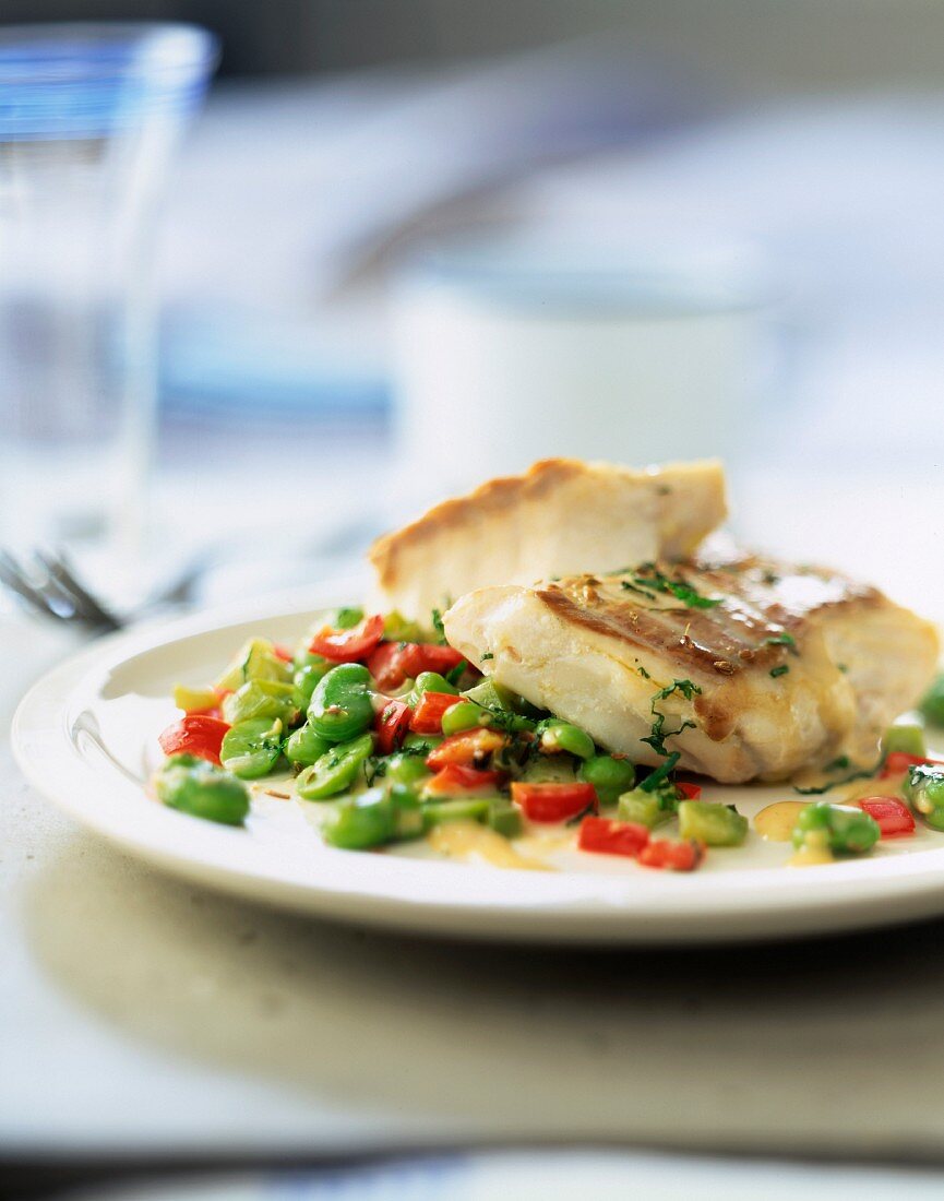 Hake steak with minted broad beans and diced red pepper