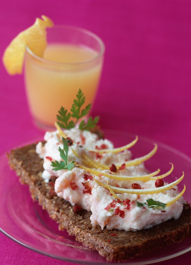 Slice of Sweedish bread with salmon mousse and pink peppercorns