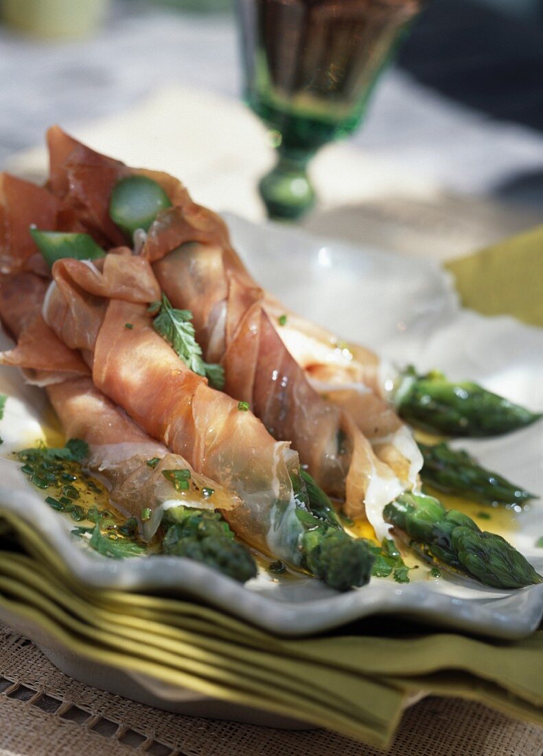 Green asparagus wrapped in Parma ham